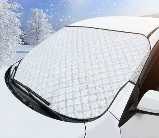 Silver quilted windshield snow cover on a white car