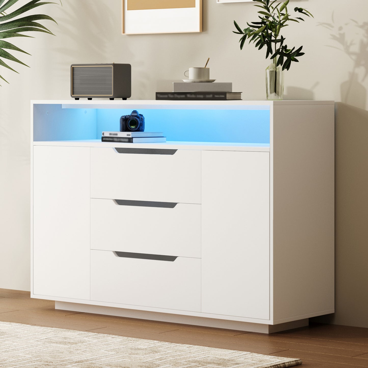 Modern White Multifunctional Cabinet With Open Shelf, Three Drawers And Doors On Both Sides. White Matt Look With Metal Rails And Rounded Edges. Ideal For Living Room, Dining Area Or Office.