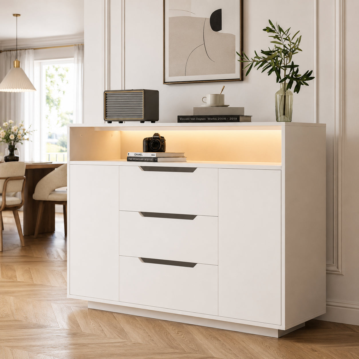 Modern White Multifunctional Cabinet With Open Shelf, Three Drawers And Doors On Both Sides. White Matt Look With Metal Rails And Rounded Edges. Ideal For Living Room, Dining Area Or Office.