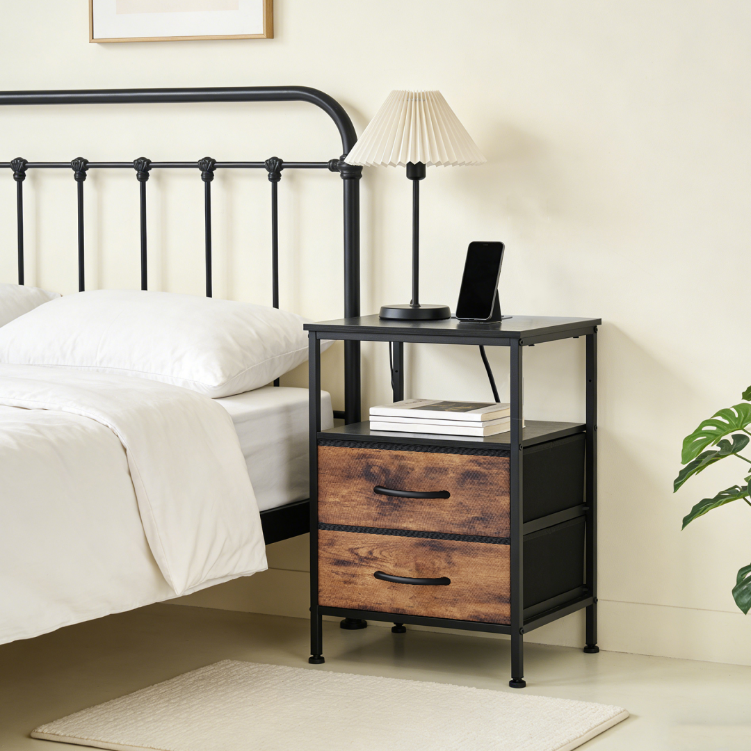 A Small Bedside Table With A Charging Station And Two Fabric Drawers, And A Side Bedside Table